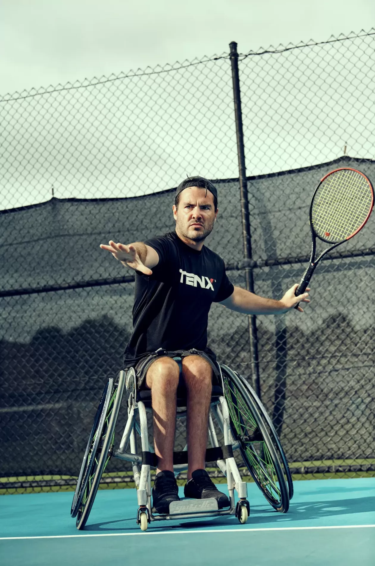 Tennis player, Marty Dunn, playing on a court